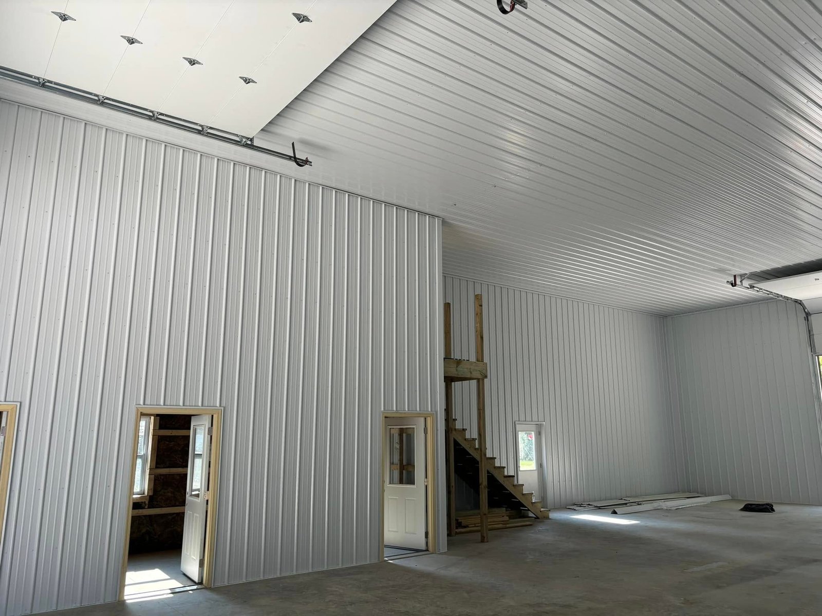 Finished inside pole barn with metal on walls and ceiling by Hershberger Construction