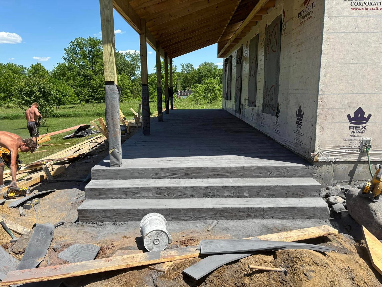 Crew cleaning up after pouring textured stamped concrete